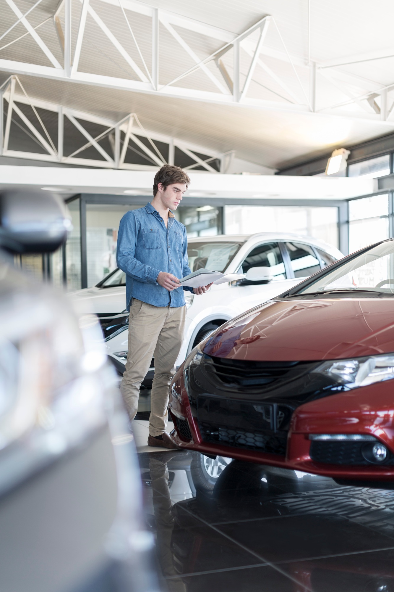 Man looking at new car at car dealership